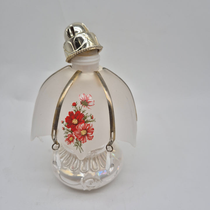 Retro parfymflaska i glas med blommor
