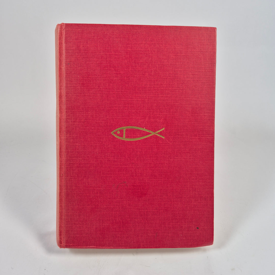 Bibel i röd tyginbunden utgåva med guldfärgad fisk-symbol