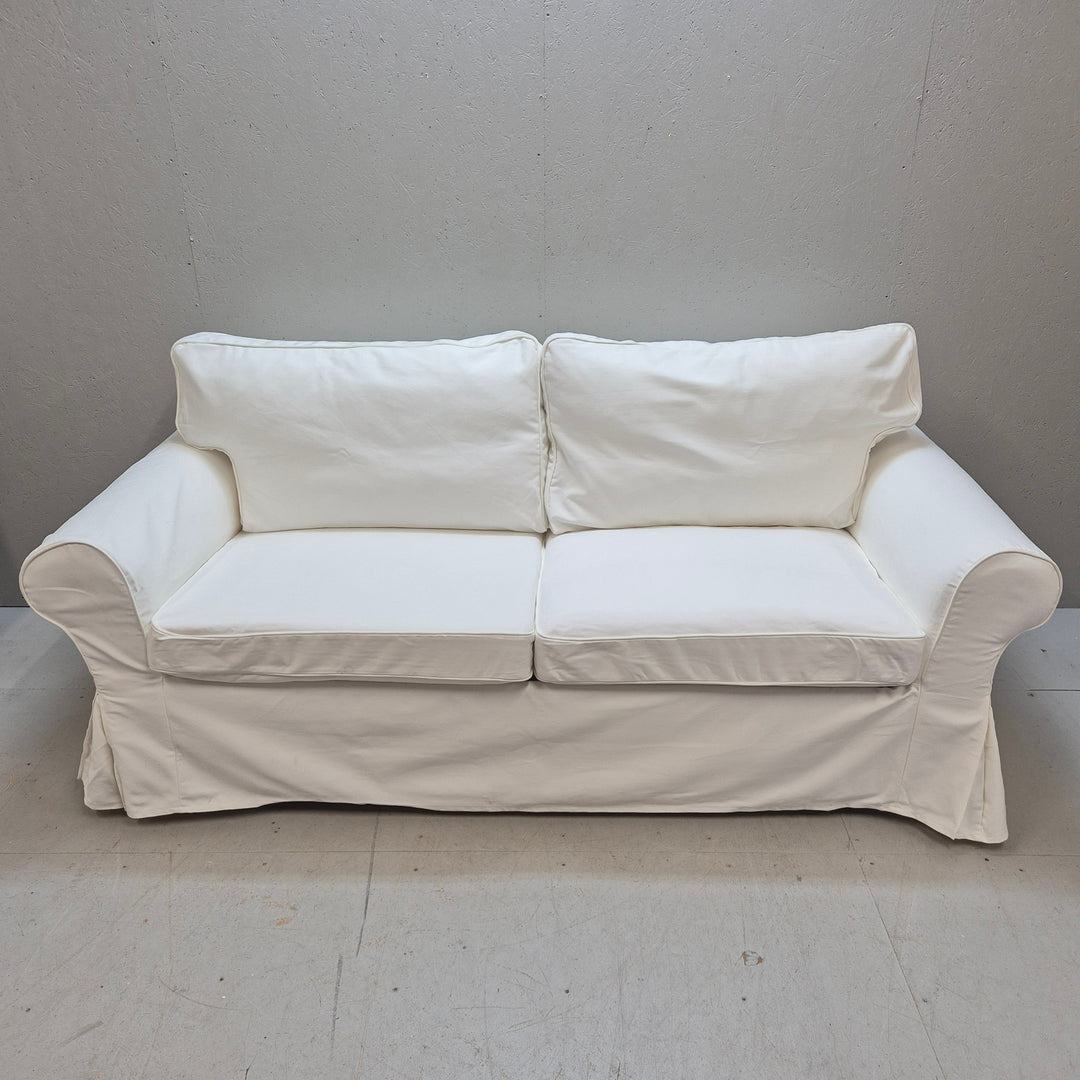 Elegant vit bäddsoffa i tyg i gott skick