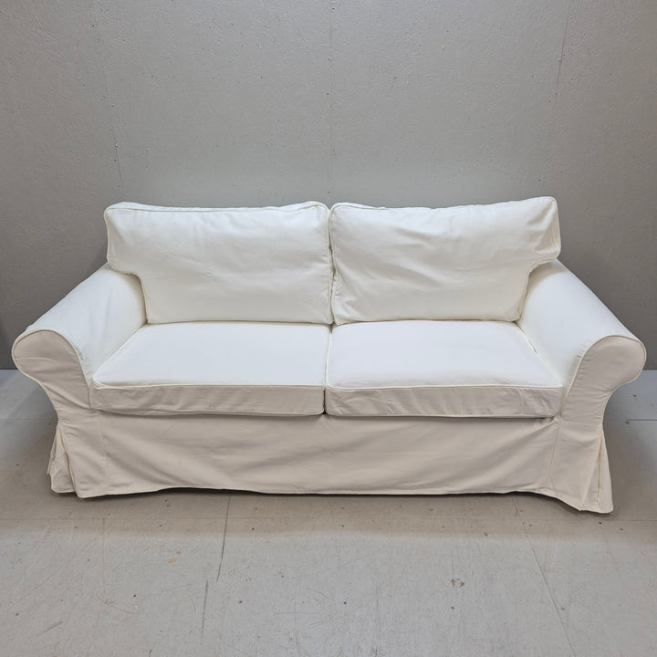 Elegant vit bäddsoffa i tyg i gott skick