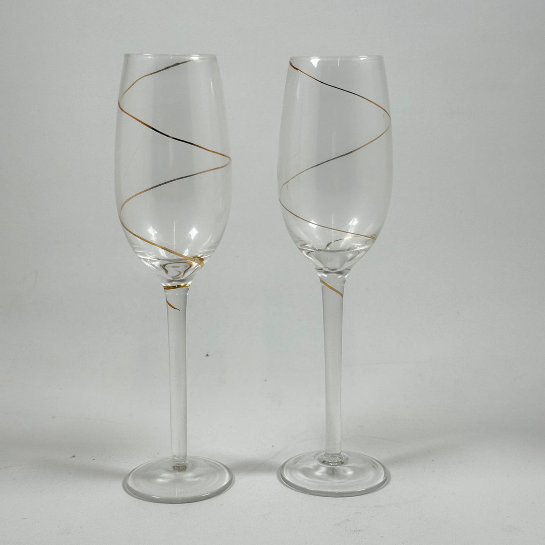 Eleganta champagneglas med gulddetaljer