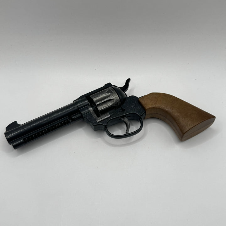 Retro leksakspistol i svart och brun plast